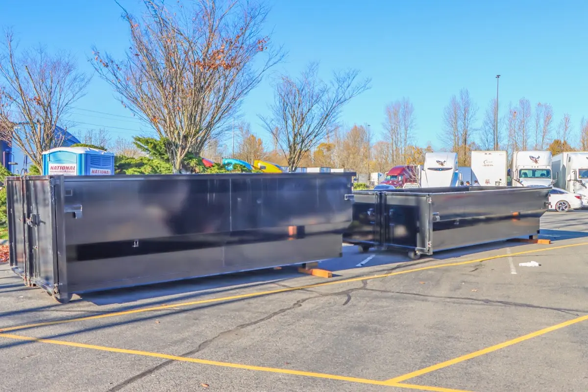 Professional dumpster rental service with roll-off container on residential driveway in Newcastle